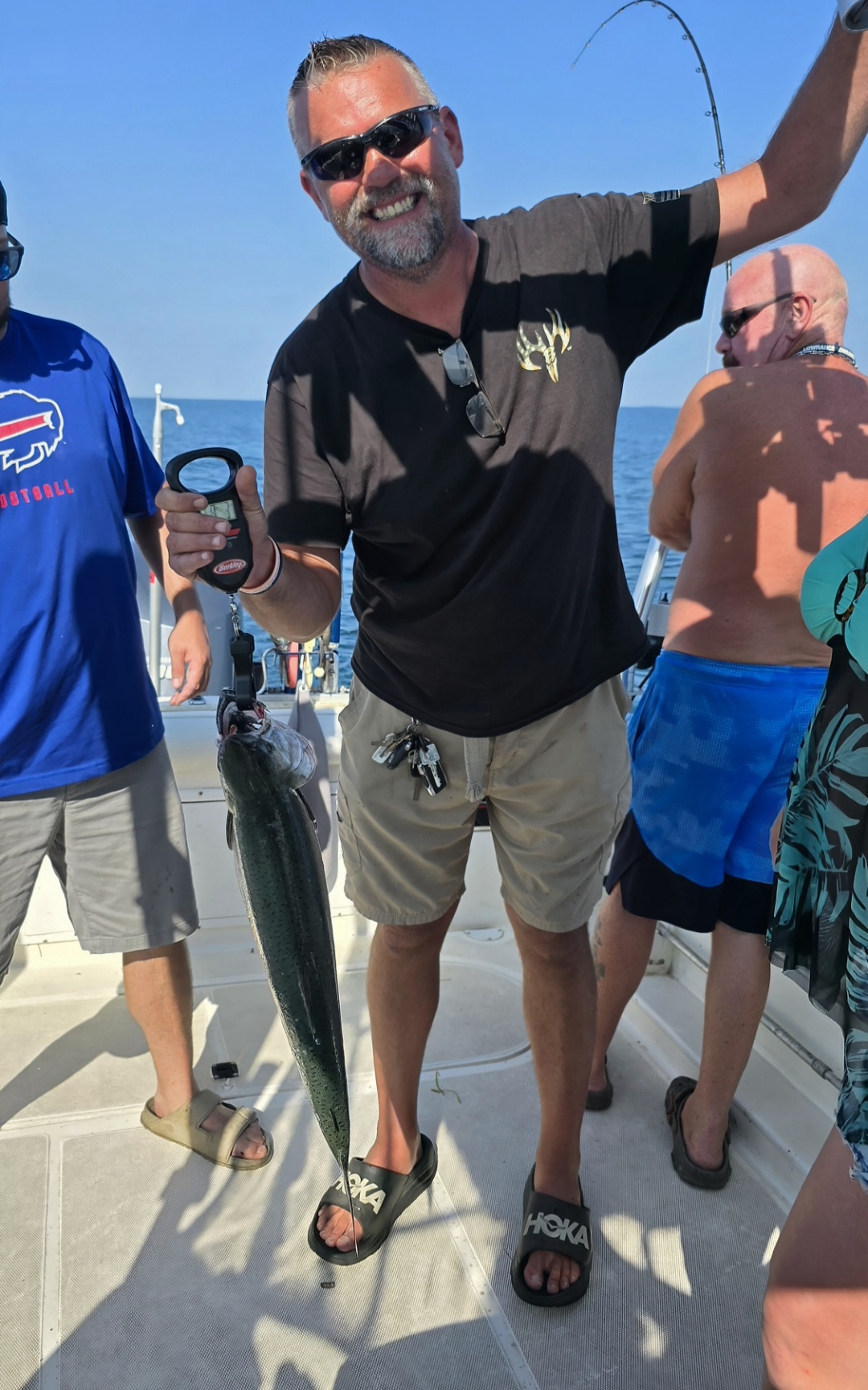 Angler weighing salmon Pro-Tek charter